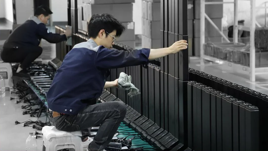 Workers checking the fit of lifting columns on the factory floor