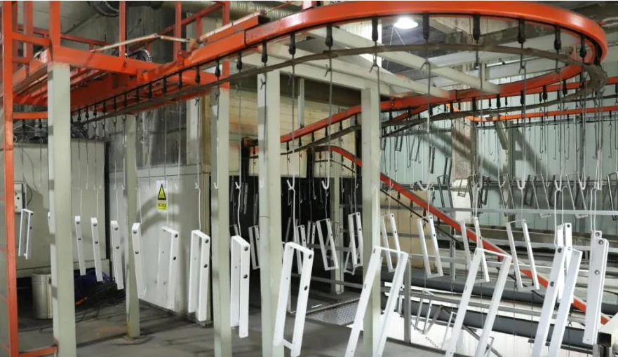 Metal frames hanging along the powder coating line
