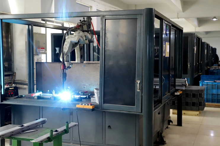 Industrial robot welding a metal structure