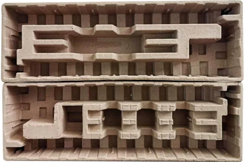 Two moulded-pulp packaging trays shaped to protect product components